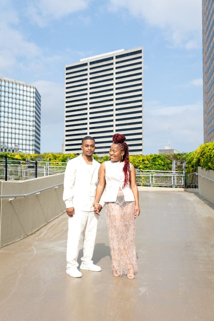 Black New Orleans couple smiling in front of the Superdome